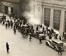 Strikers and bystanders pursued by mounted police using teargas