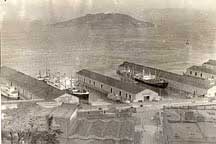 Circa 1920s, bulkhead wharf and piers are open to public view.